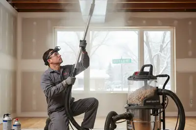 Technician cleaning air ducts with professional equipment at Buffalo, NY home for AC repair service